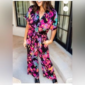 NWT multi color jump suit, size large